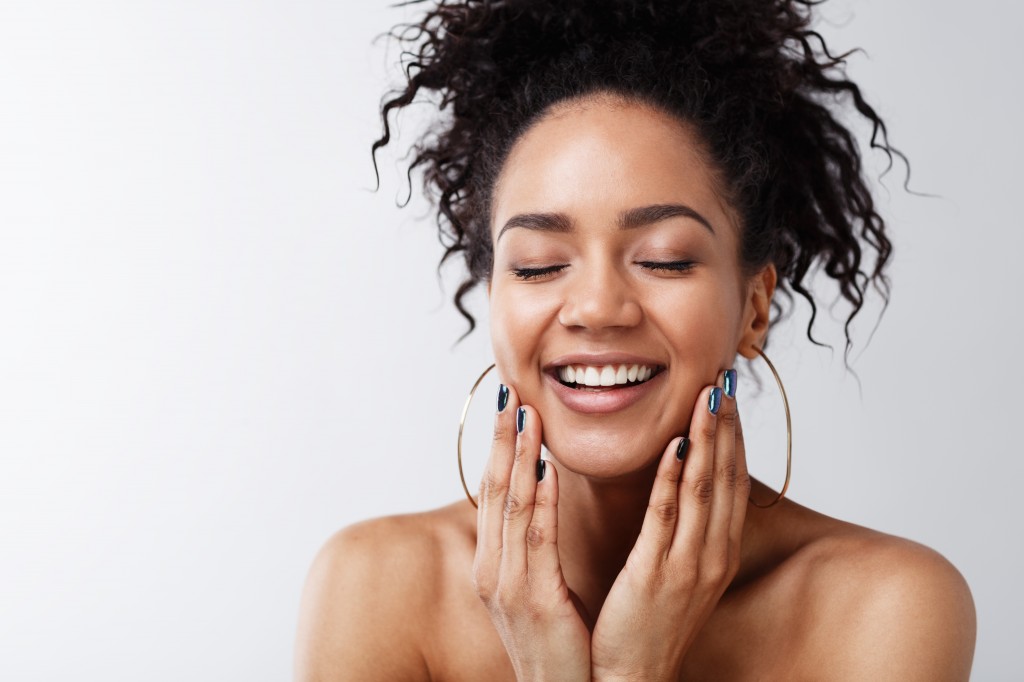 Portrait of happy female with her eyes closed